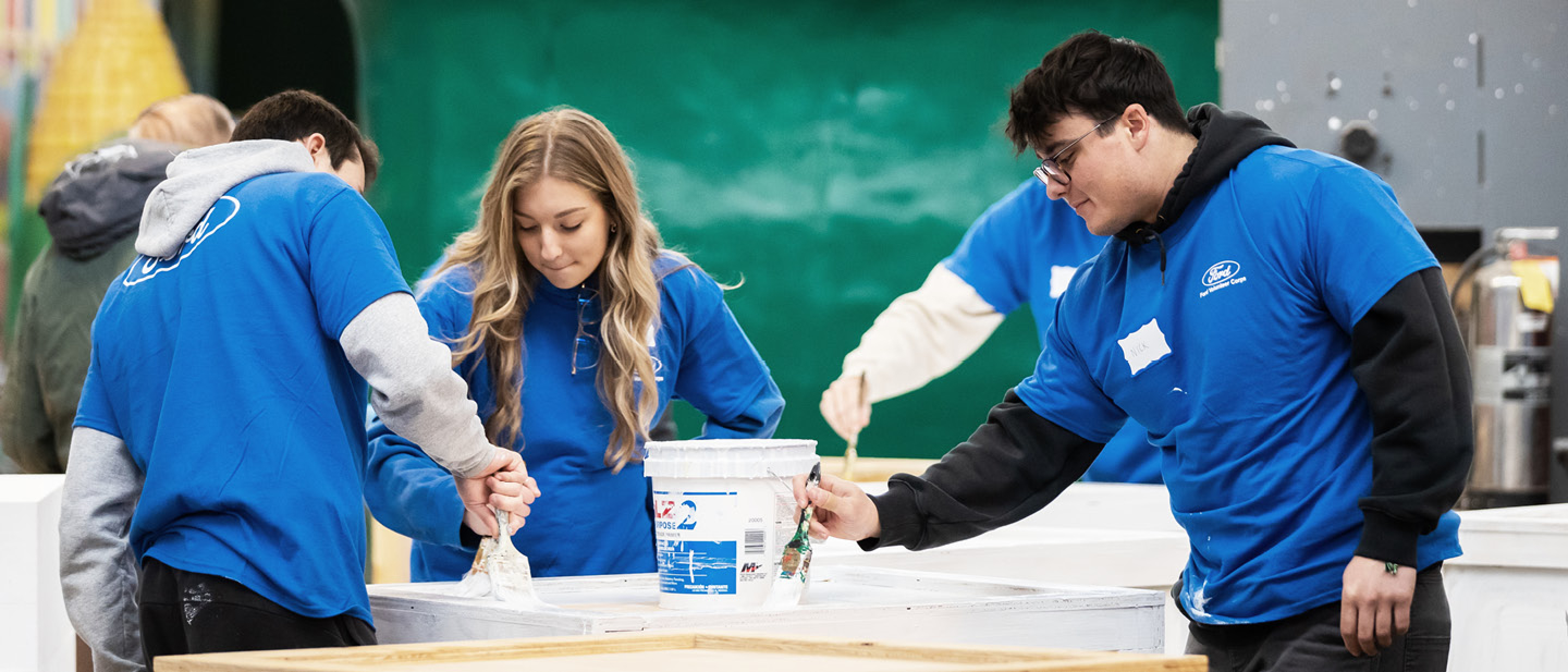 A group of volunteers doing a painting job